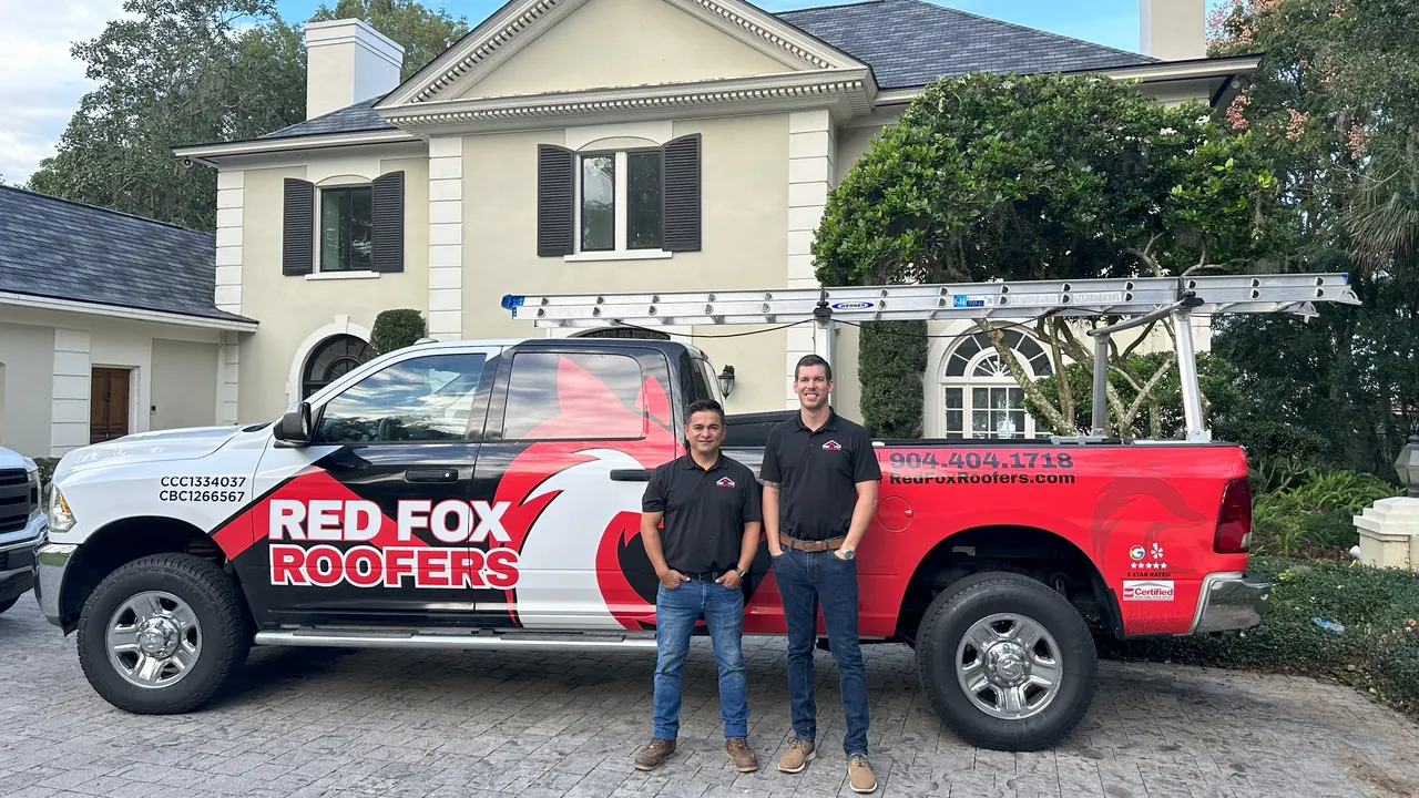 Red Fox Roofers co-owners beside a company truck