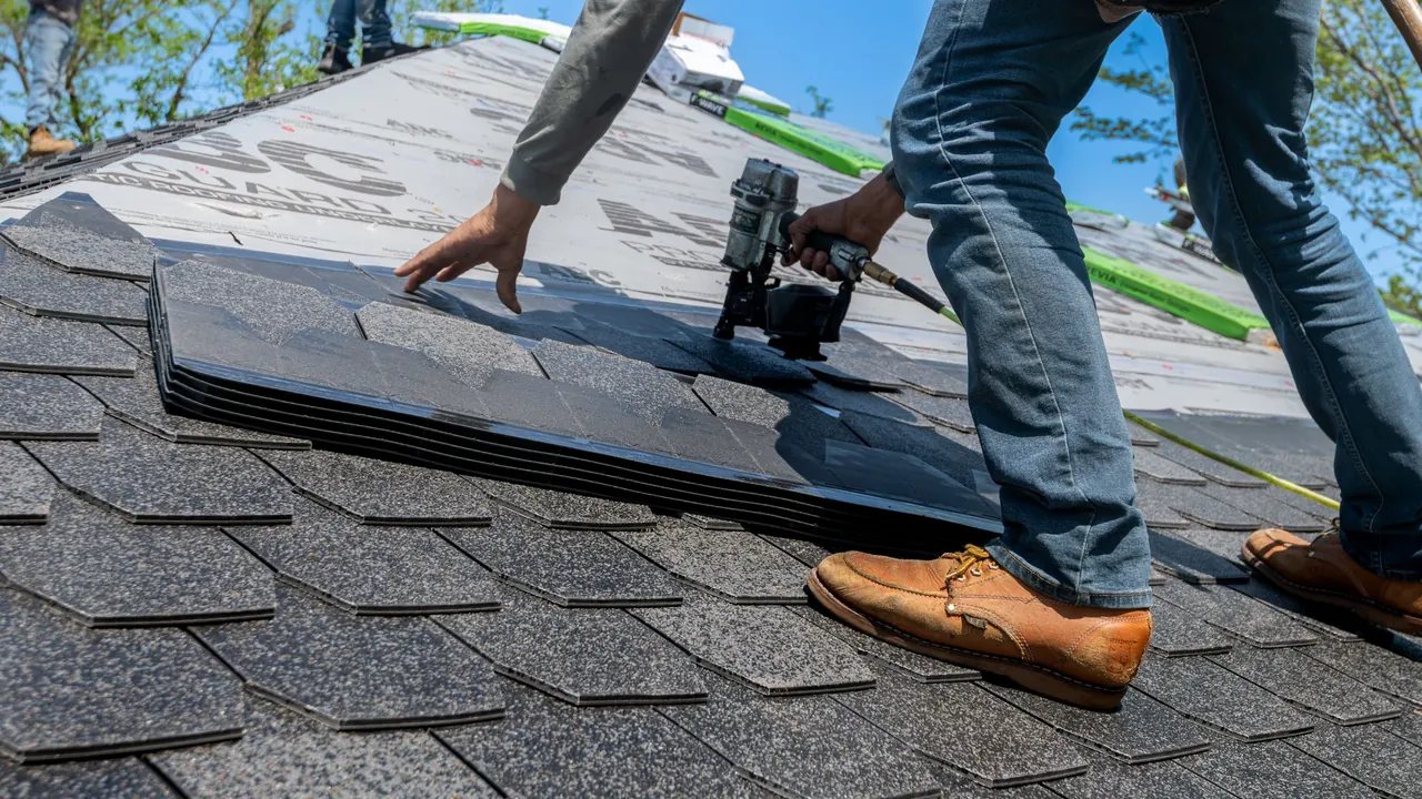 Roofer installing shingles