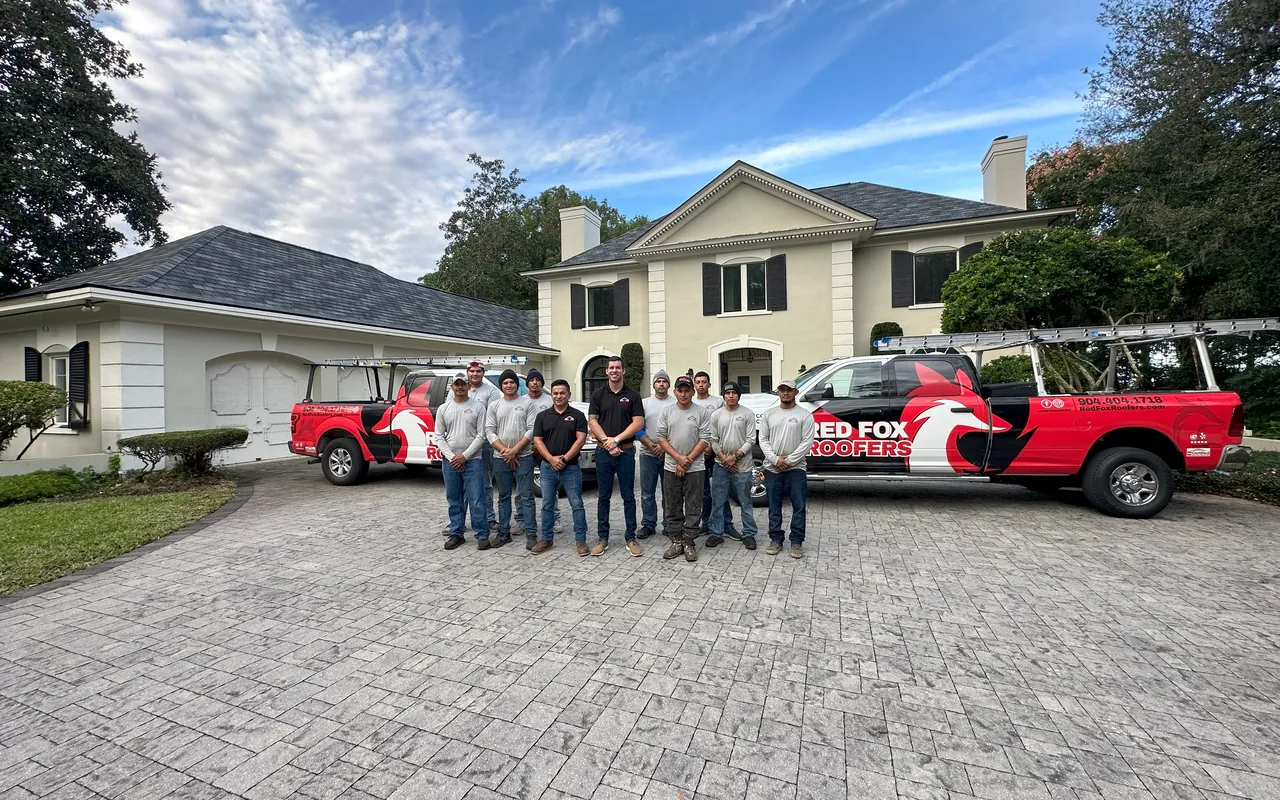 The Red Fox Roofers crew with company trucks