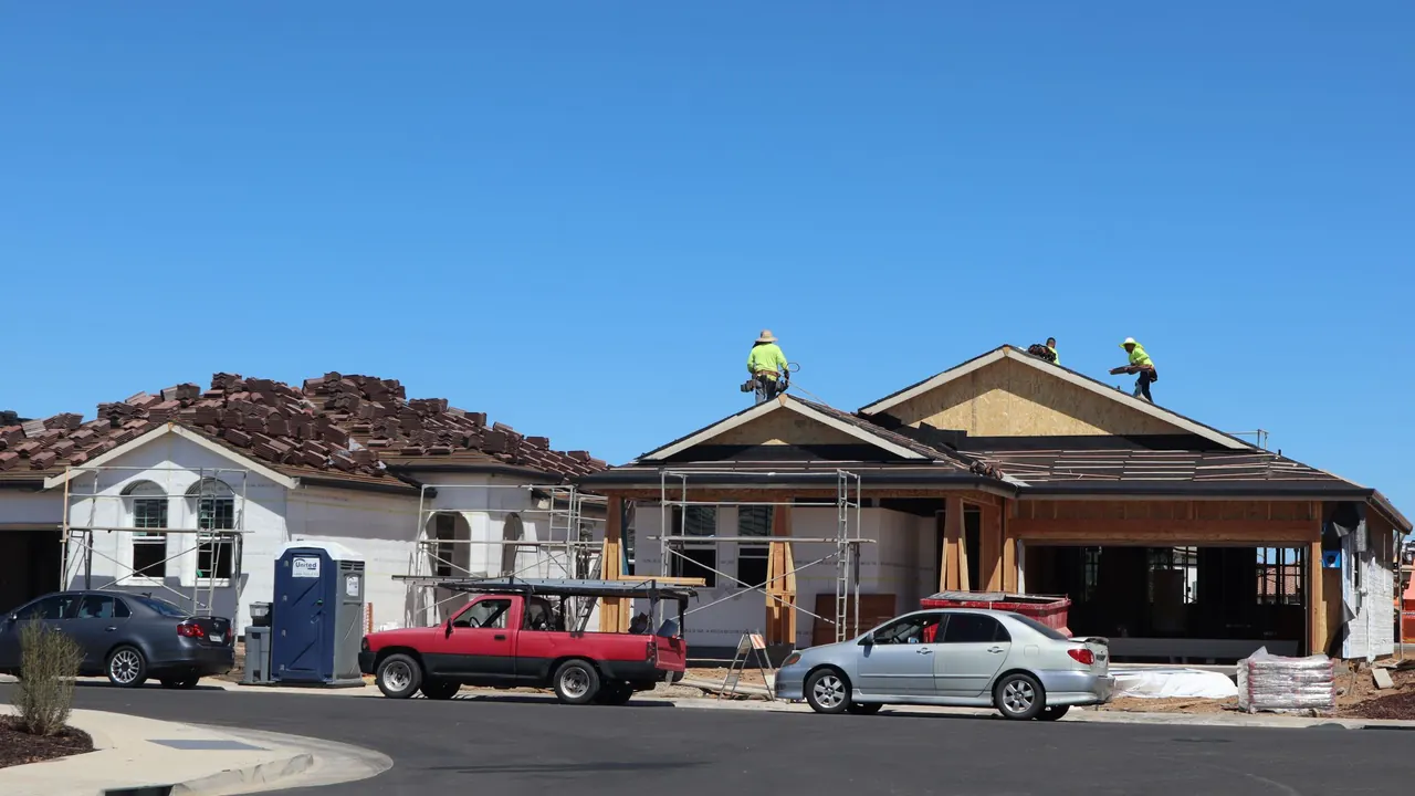 Roofing crew working on a new home